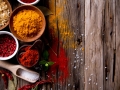 Assorted spices on wooden background